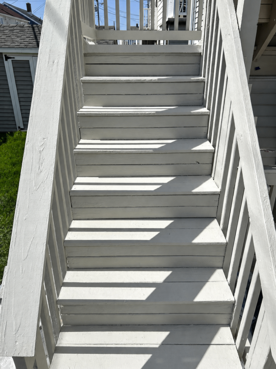 Freshly painted gray stair treads and handrails