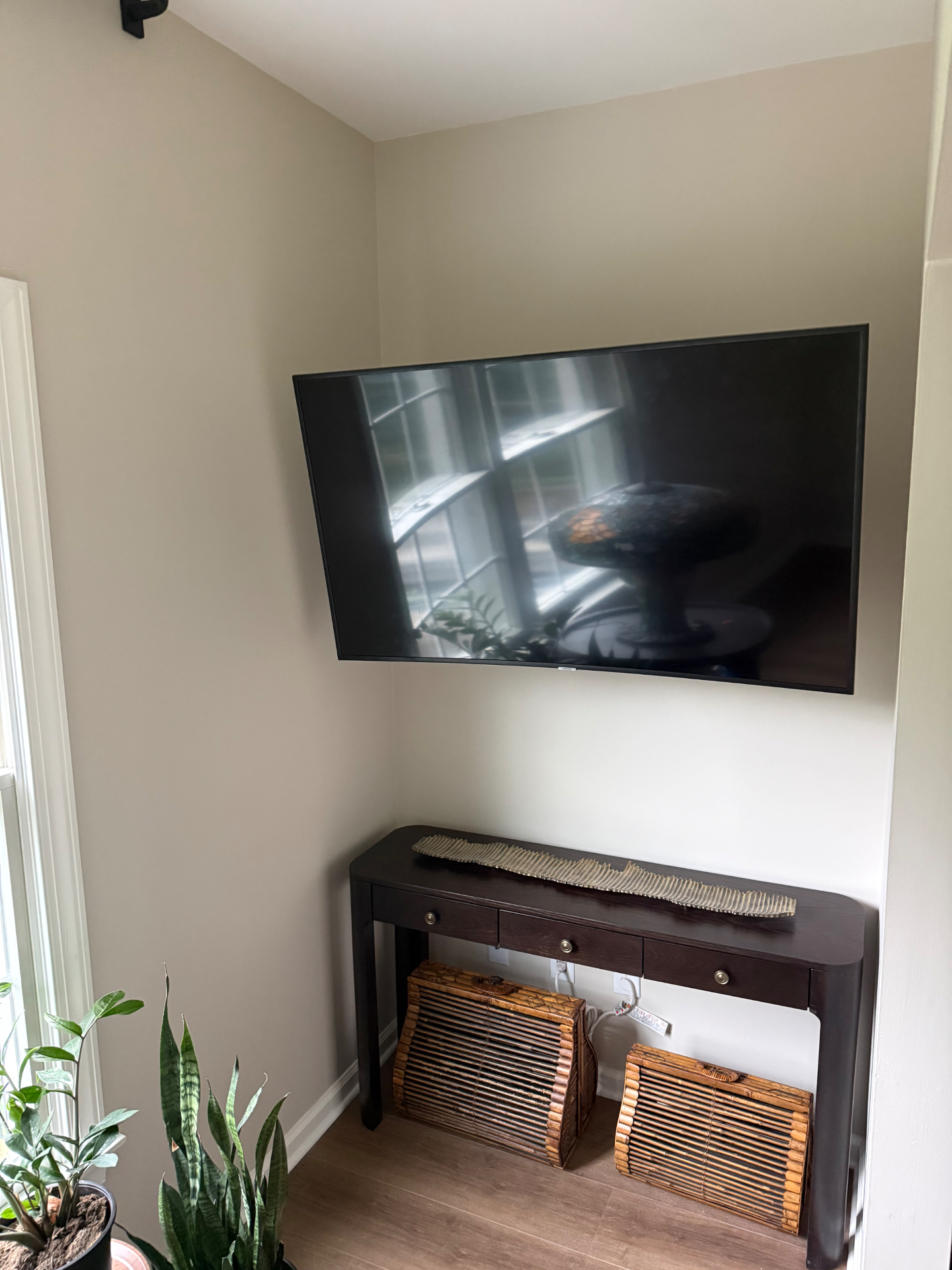 Flat-screen TV mounted flush on a living room wall with hidden wiring